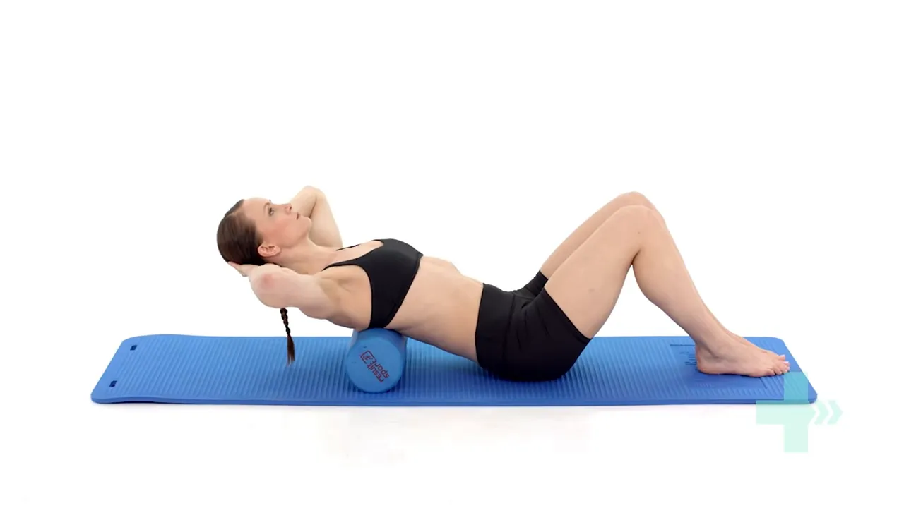 Person performing a deep thoracic extension on a foam roll with chest lifted and hips on the mat, demonstrating proper foam-roll placement.