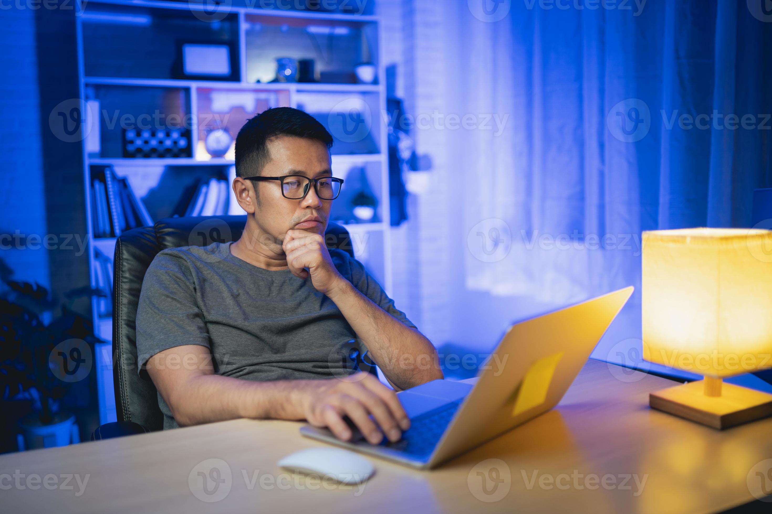 freelance man working on laptop At home at night. Man freelancing ...