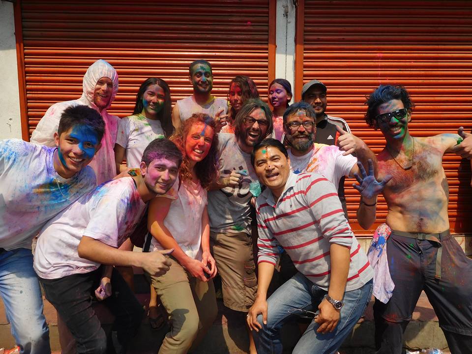 Tourists immersed in vibrant colours during Holi celebration in Kathmandu.
