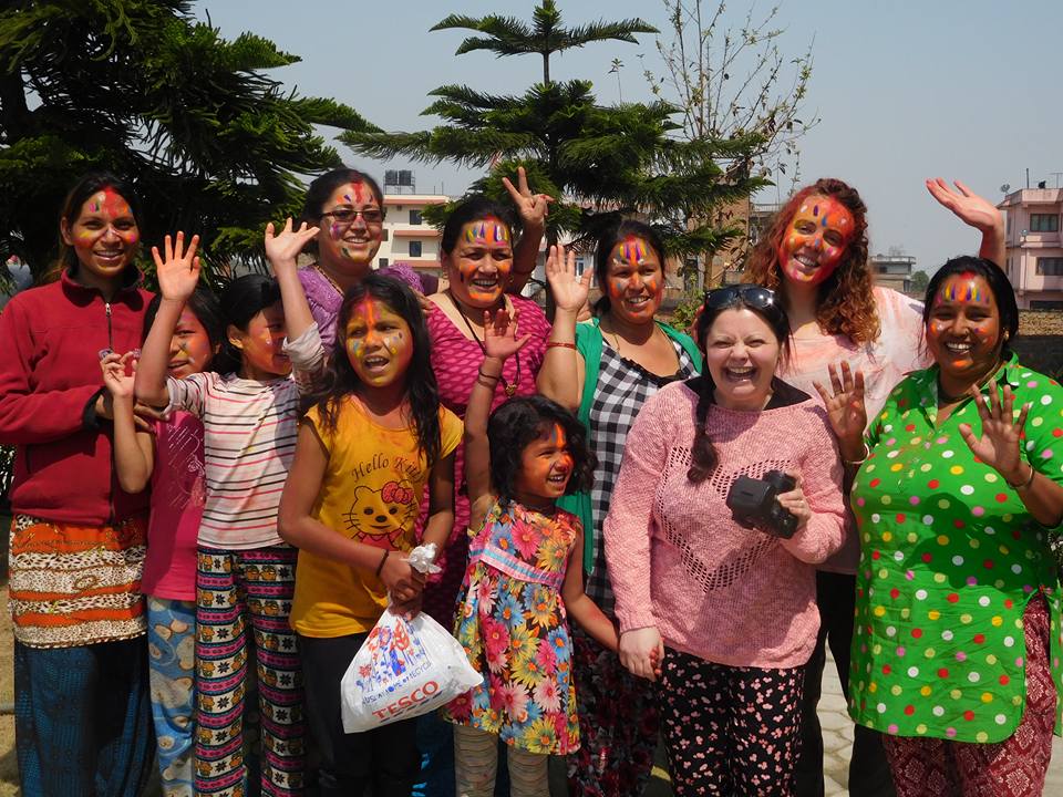 Foreign tourist and Nepalese girls and women joyfully celebrating the colourful festival of Holi in Kathmandu.