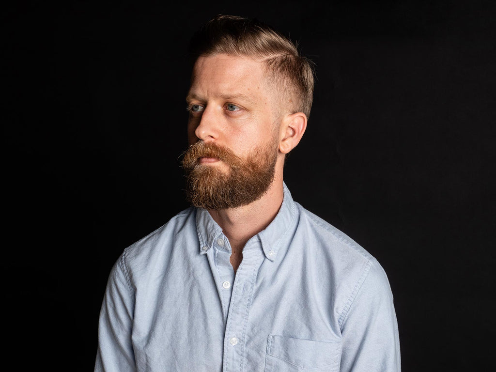 Blonde man with a blonde faded beard.