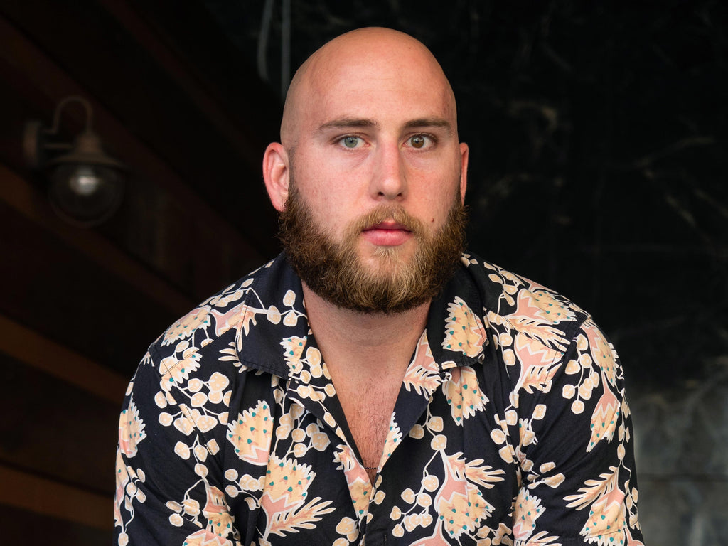 bald man with a blonde short rounded beard.