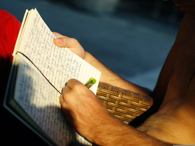 Person writing in a gratitude journal to build a positive mindset and improve daily mental well-being.