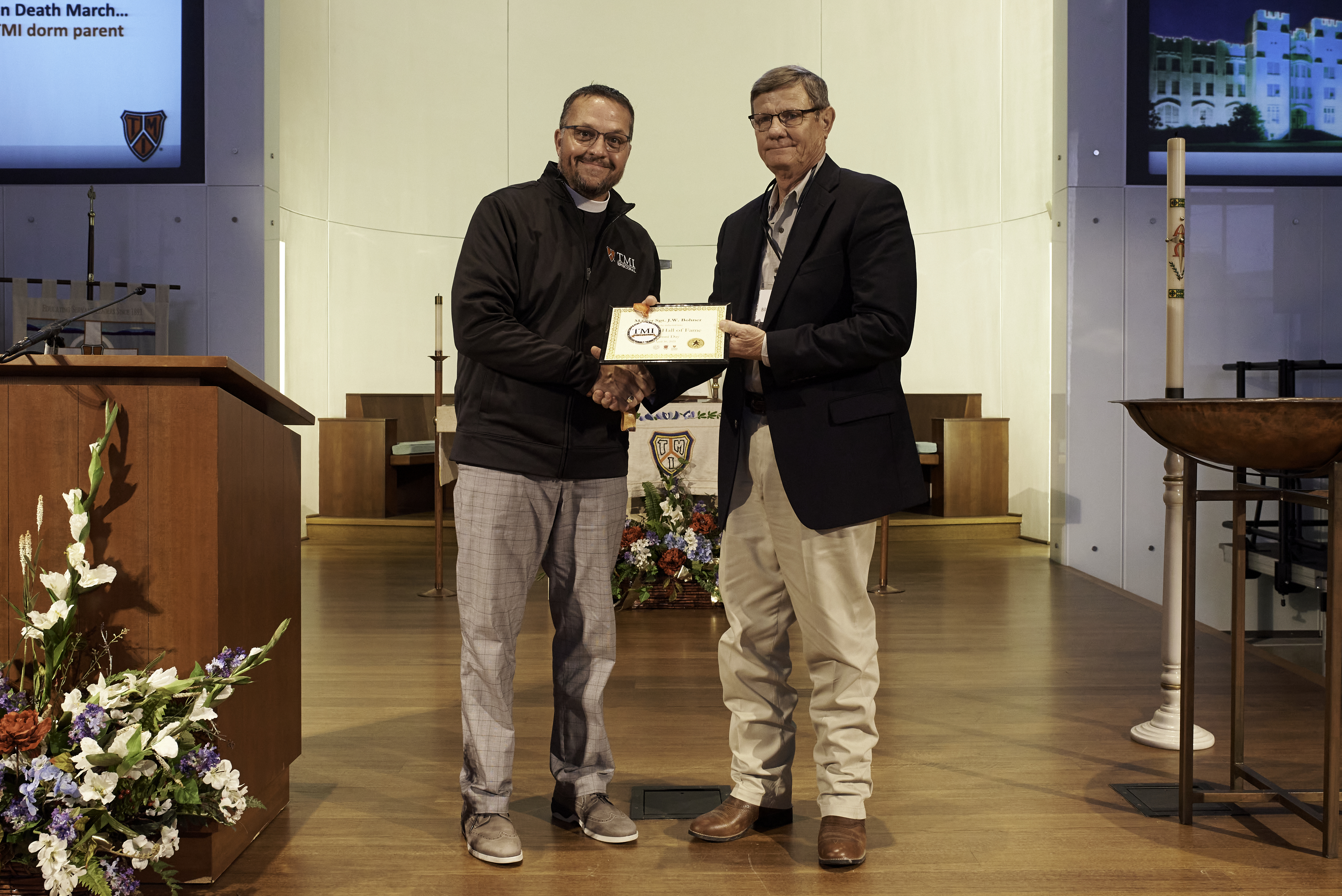 Bill Thompson '72 accepts award for Sgt. Bohner from Father Scott.jpg