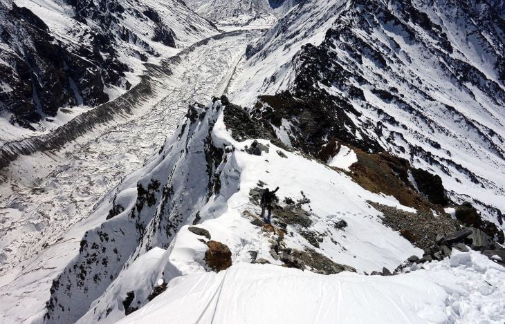 Yala Peak (5,732 meters) transformed into a captivating snowy scene in the Langtang region of Nepal. The image captures the pure and tranquil essence of the Himalayas, with the peak blanketed in freshly fallen snow, creating a breathtaking winter spectacle.
