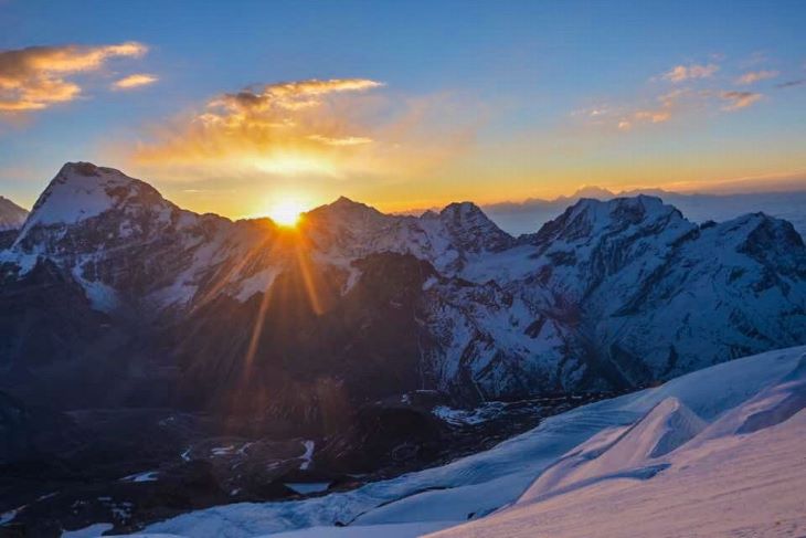 The first light of sunrise gently gracing the slopes of Lobuche East Peak in the Everest region of Nepal.