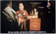 A person in a robe speaking into a microphone Description automatically generated