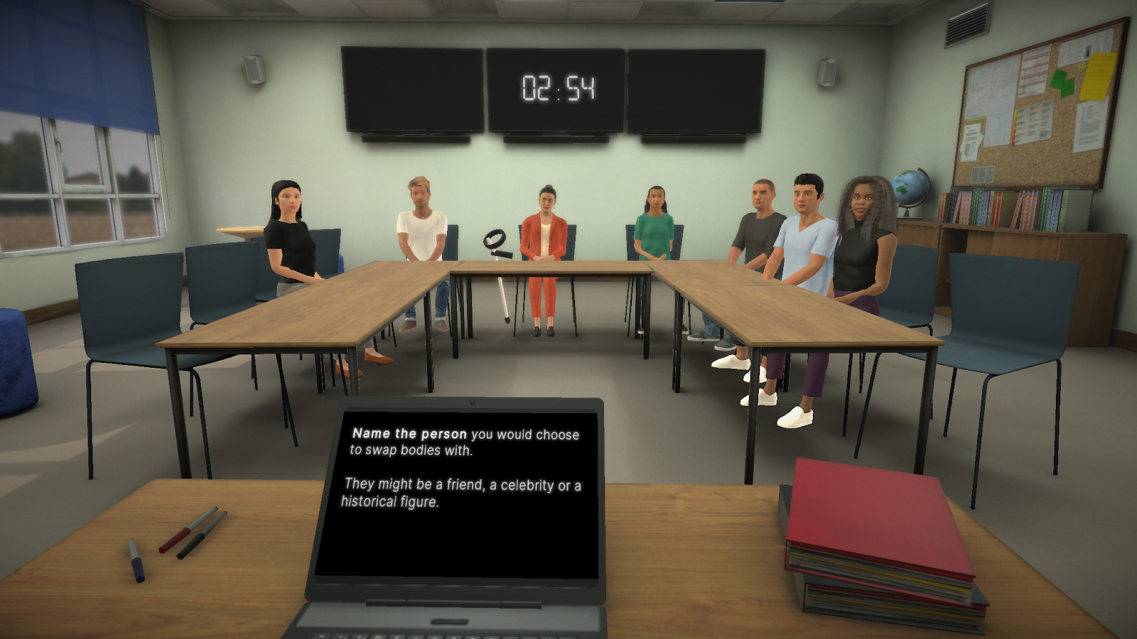 In-app capture of the user speaking to people seated around tables in a classroom (classroom setting); laptop screen shows text and a large digital clock reads "02:54.
