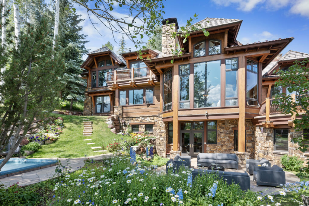 Two Creeks Home in Snowmass, Colorado in Summer. Back patio with flowers in bloom.