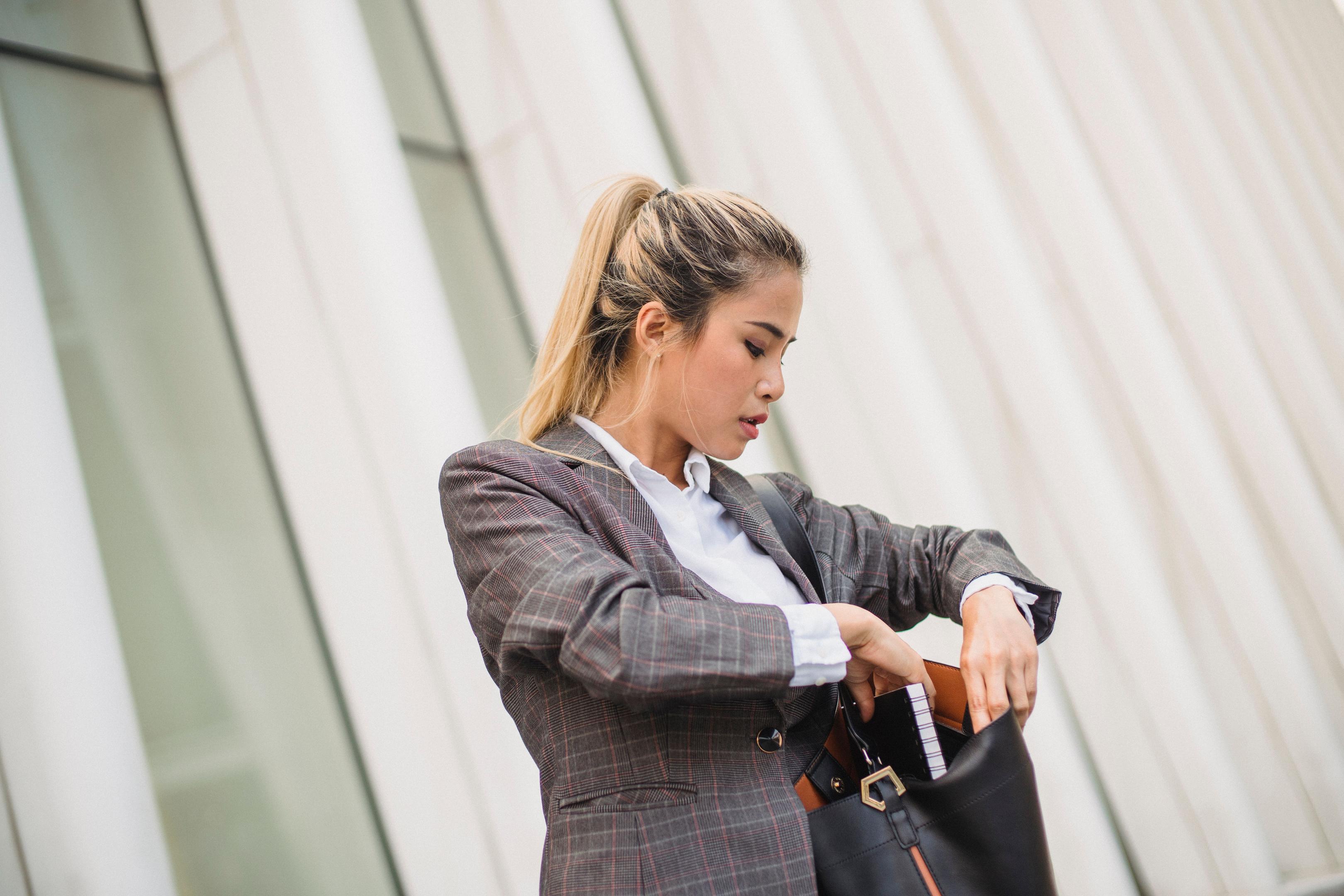 Woman loading her Work Bag notebook, laptop,, and other essentials on her way to work.
