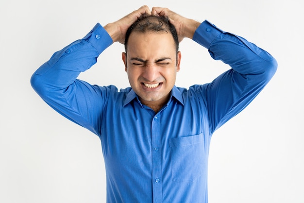 Free photo portrait of mid adult businessman crying holding head in hands