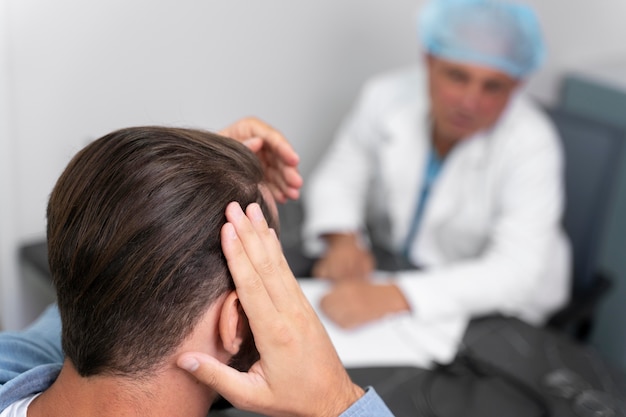Free photo adult male doing a follicular unit extraction