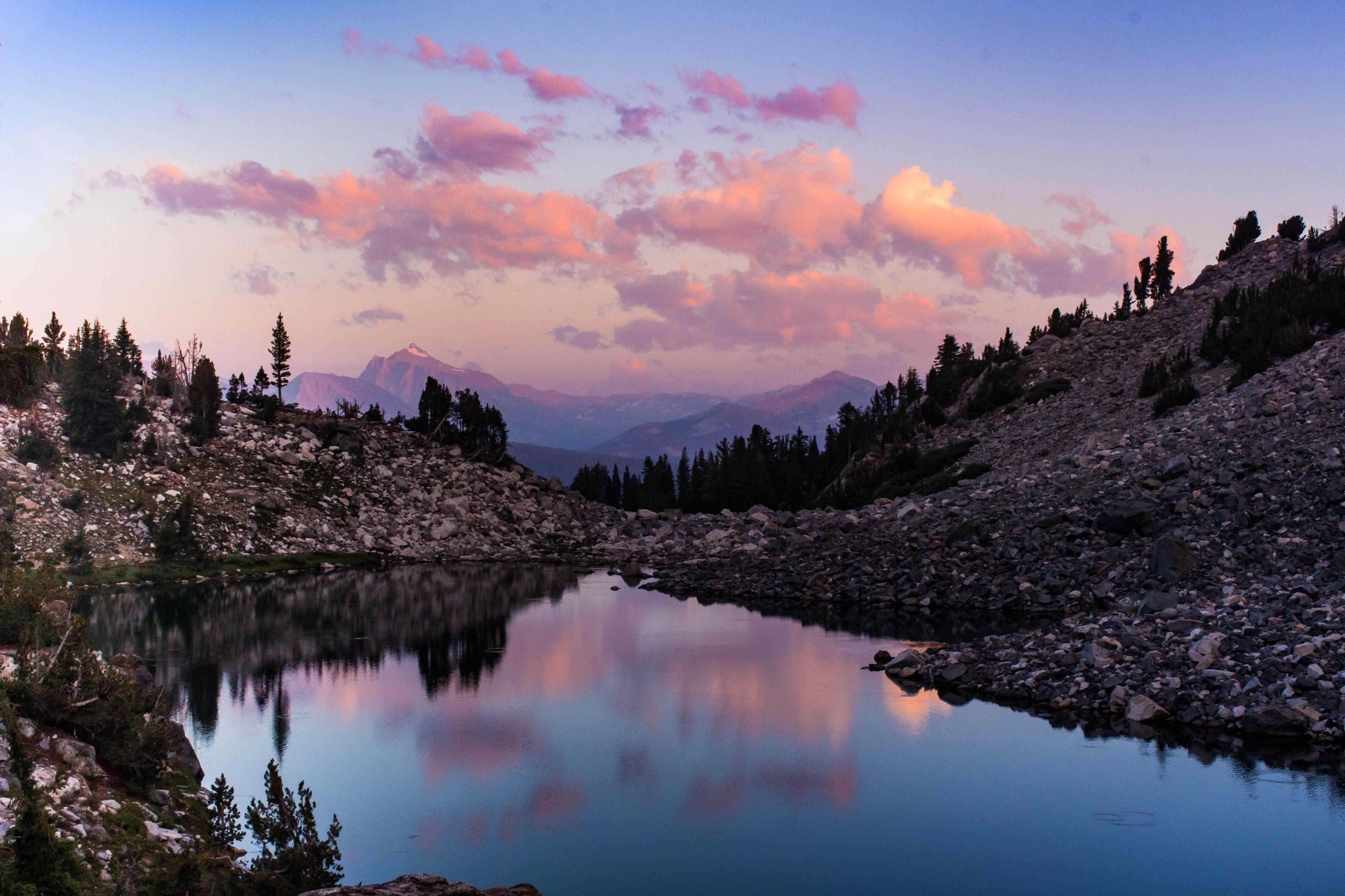 A photo overlooking a lake in the Sierra Nevada mountains at sunset