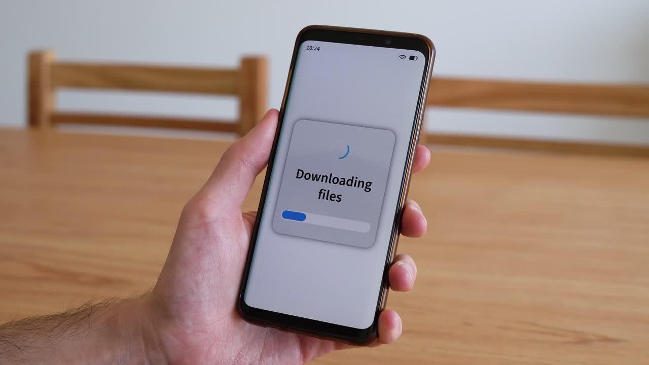 Downloading files with your smartphone. Concept of piracy through mobile apps | Premium Stock Video Footage